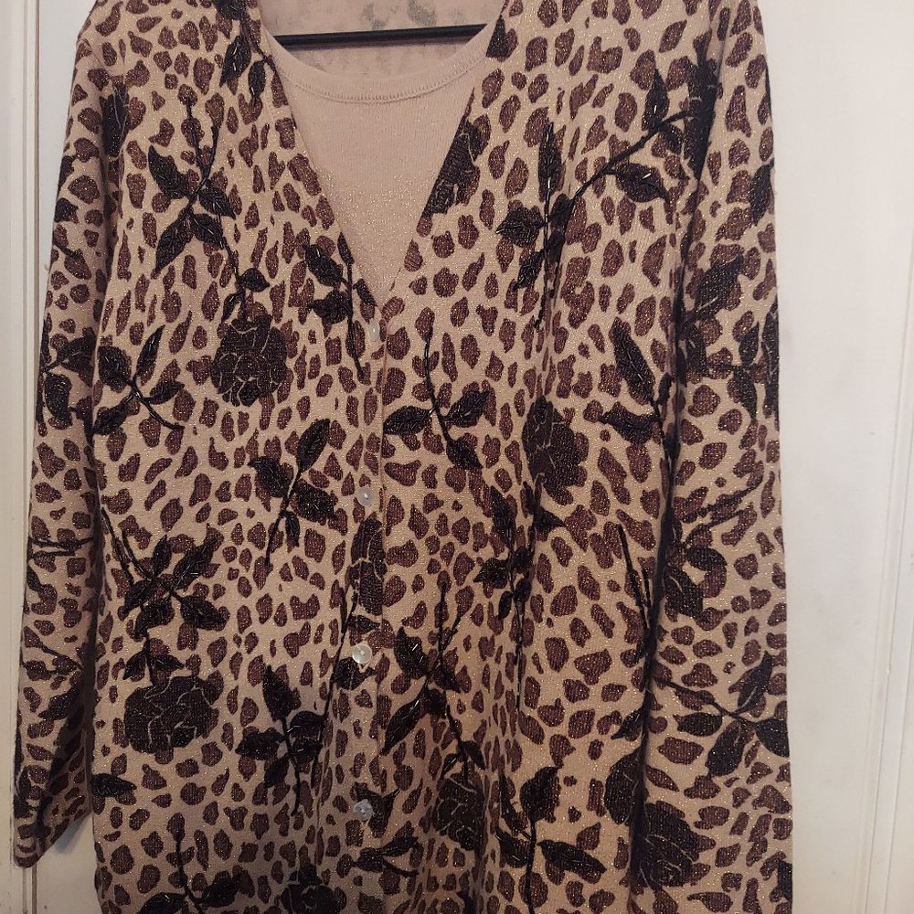 In Knit cream, black, brown and gold sweater.